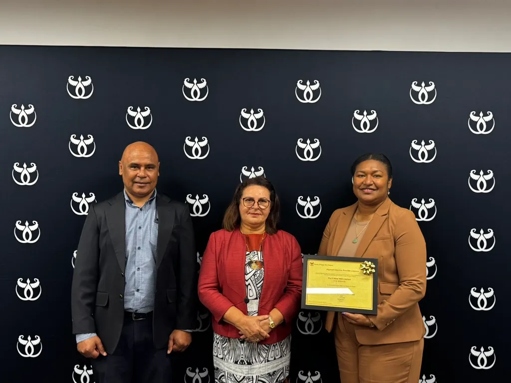 The Pay It Now PNG team with the company's Payment Service Provider licence at the BPNG office