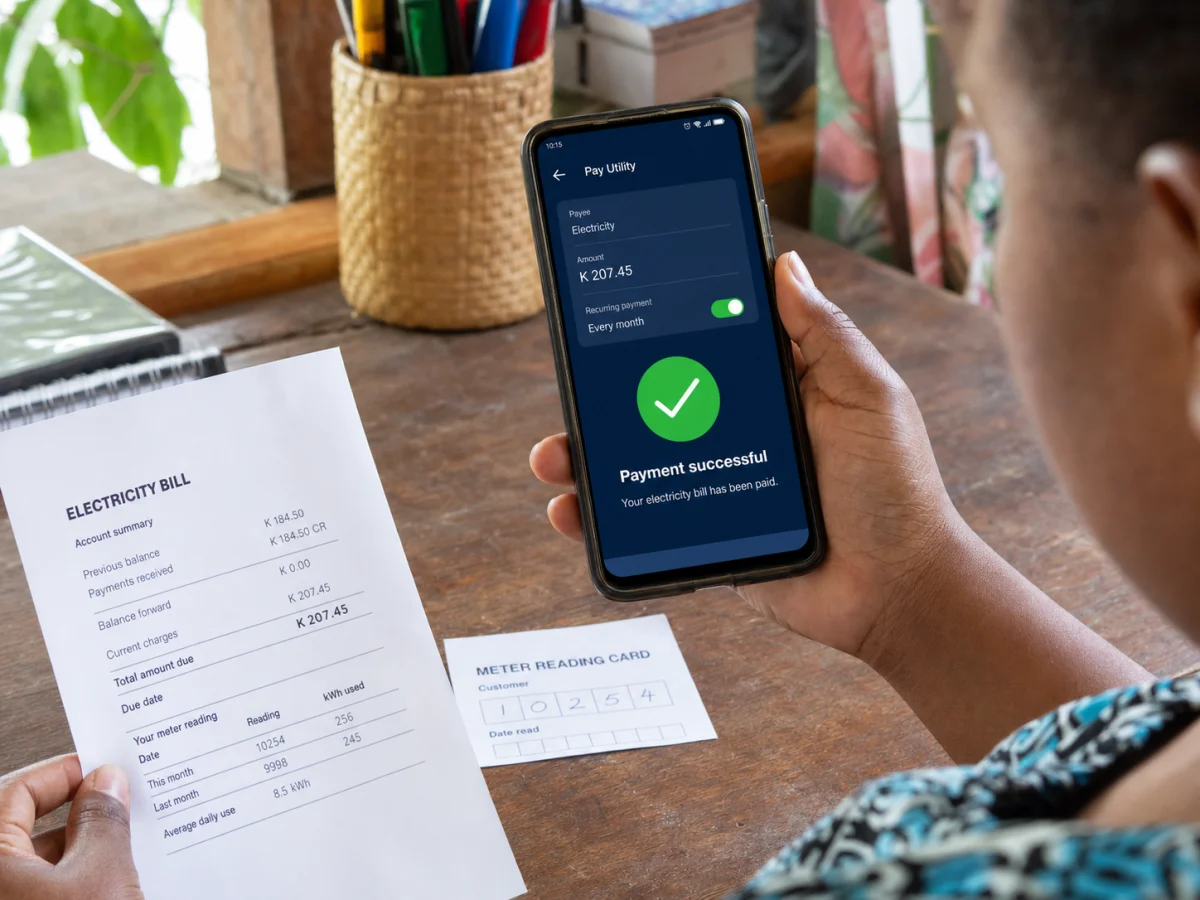 Papua New Guinean customer confirming a recurring electricity bill payment on a phone