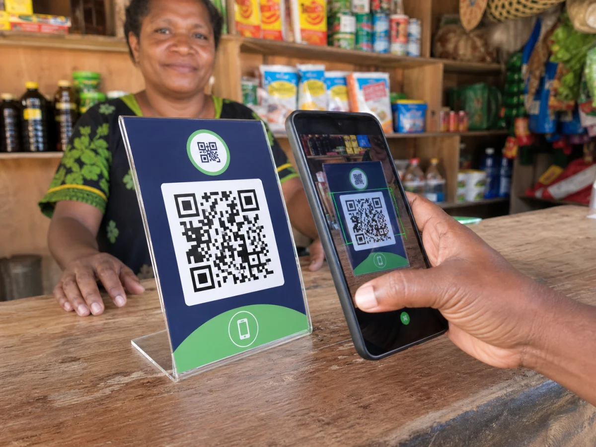 Customer scanning a merchant QR code at a Papua New Guinea trade store